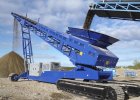 Crawler conveyor on muddy terrain offering efficient material handling