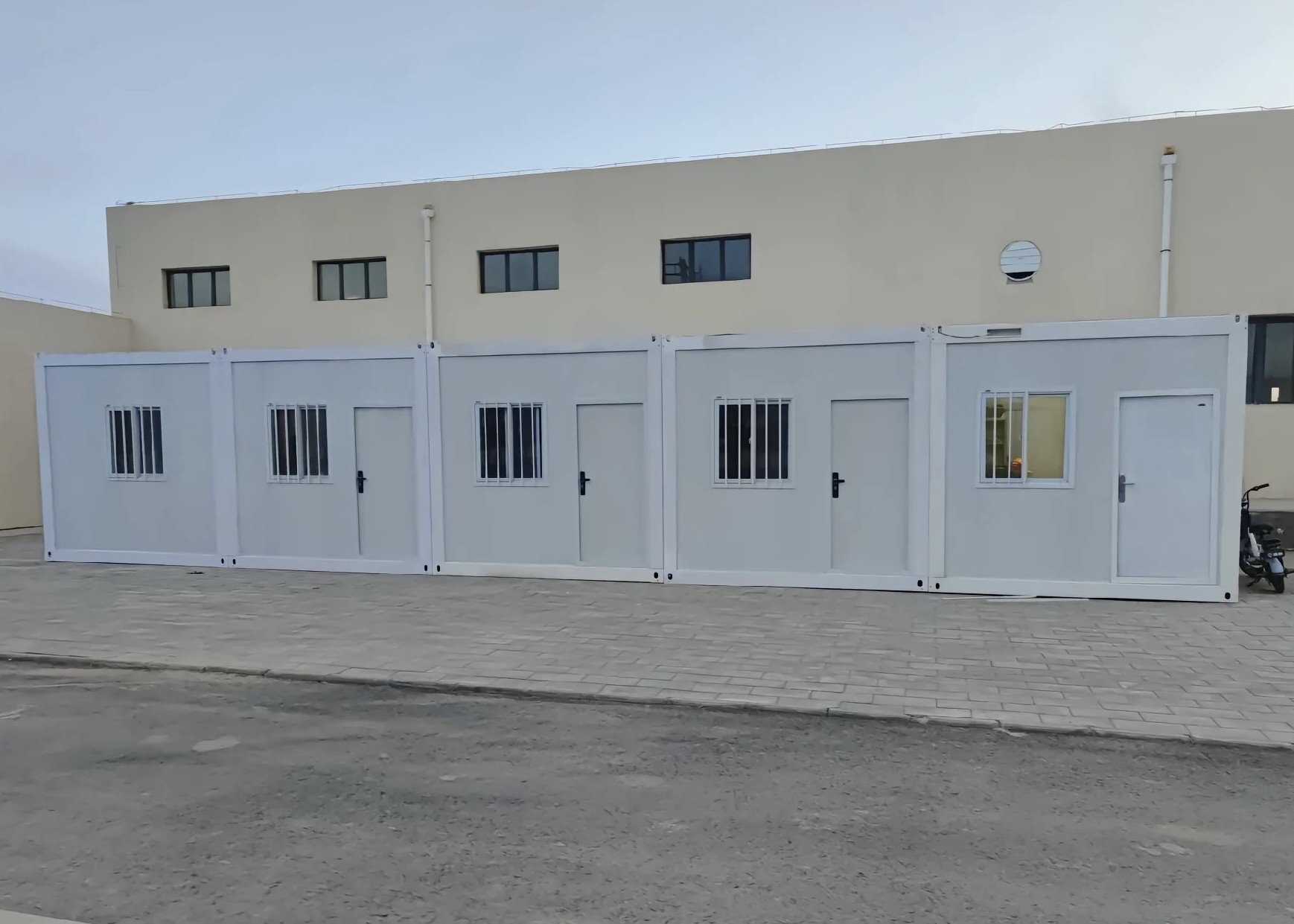Portable container building with multiple functional rooms