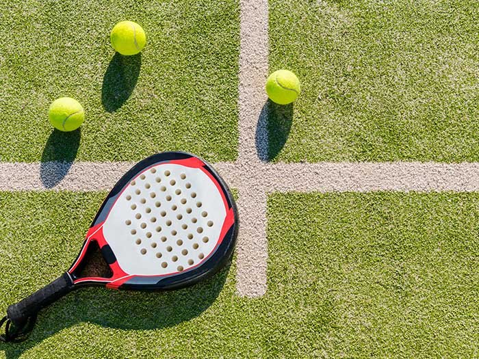 Cushioned synthetic grass tennis surface