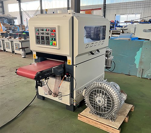 Brush sanding machine with a vacuum table