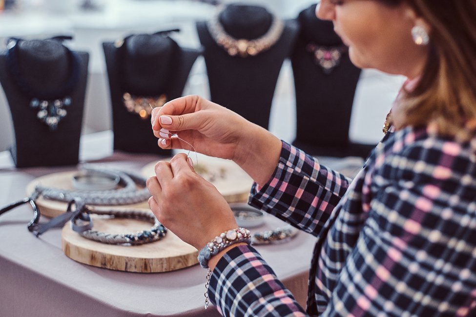 elegantly-dressed-woman-makes-handmade-necklaces-working-with-needles-thread-jewelry-workshop(1)