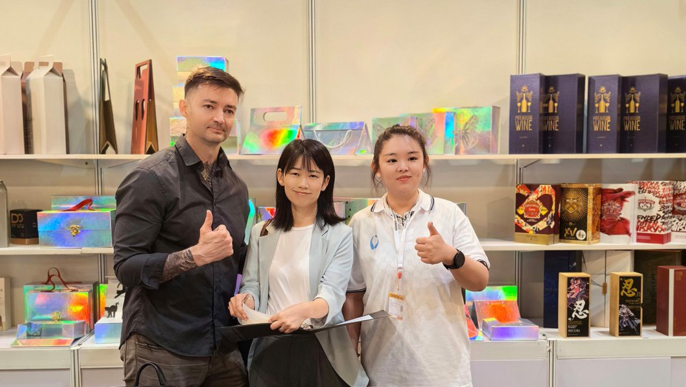 Visitors engage with our booth, exploring packaging printing innovations lively.