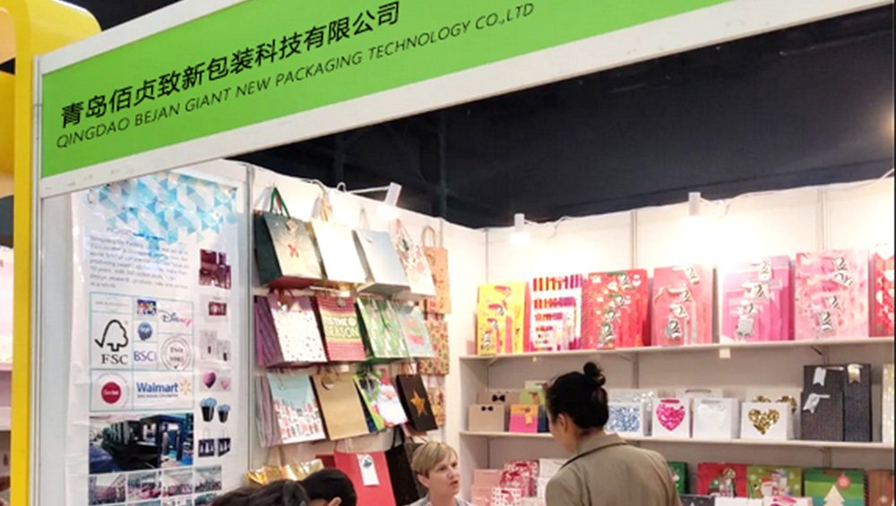  Guests interact warmly at our booth, learning about packaging solutions.